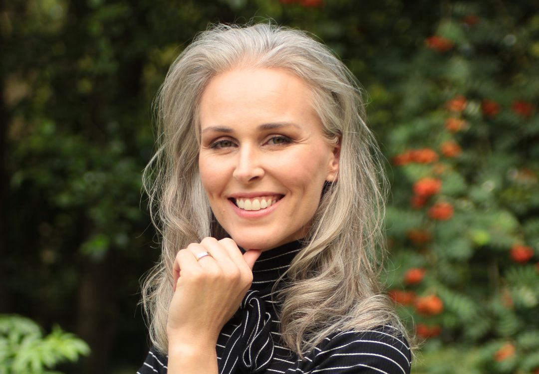 Confident smiling mature female bachelors graduate in natural health outdoors with natural background